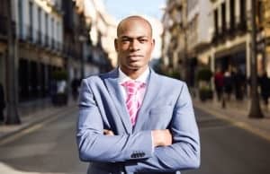Handsome black man wearing suit in urban background
